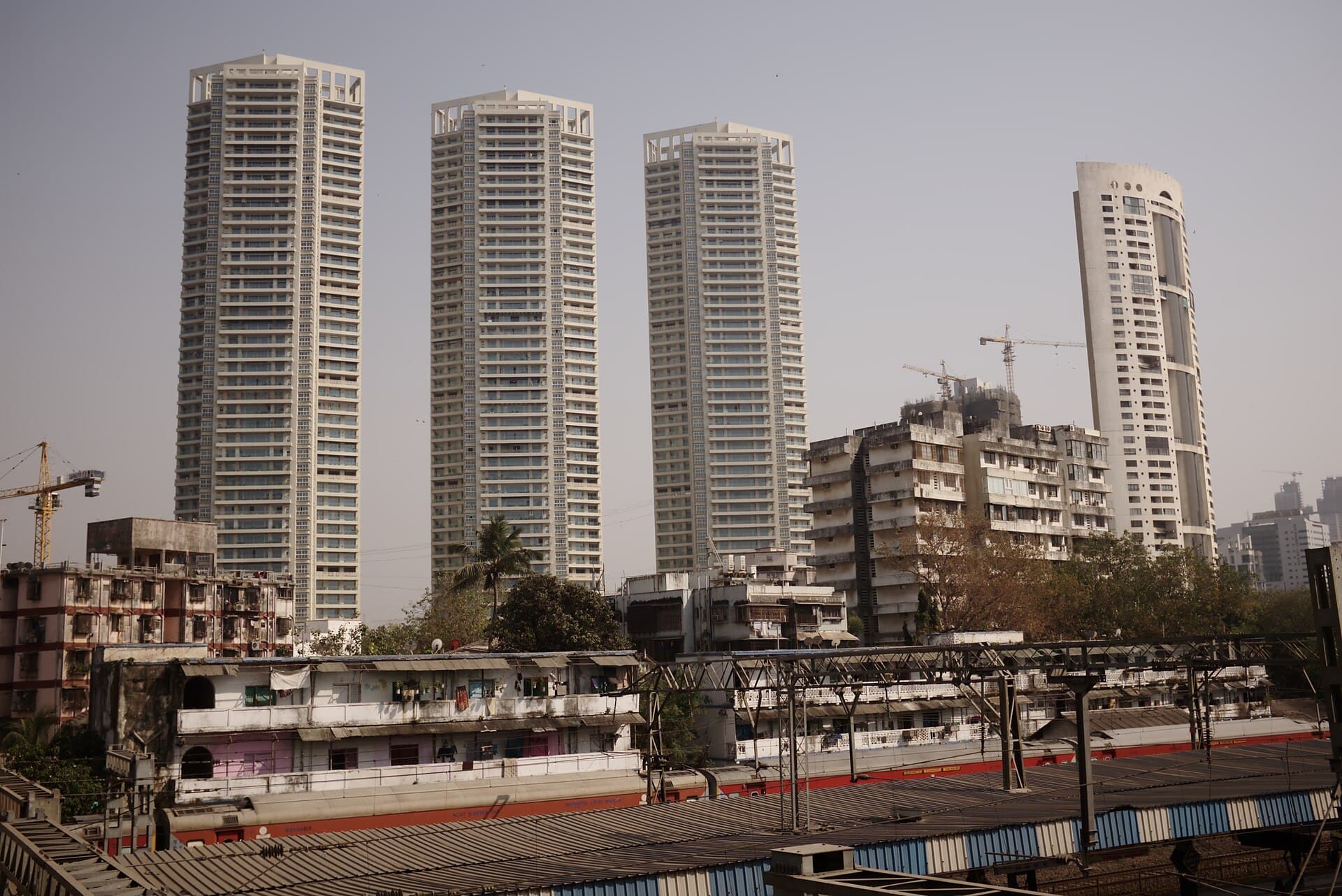 New residential towers rising behind older buildings in Mumbai